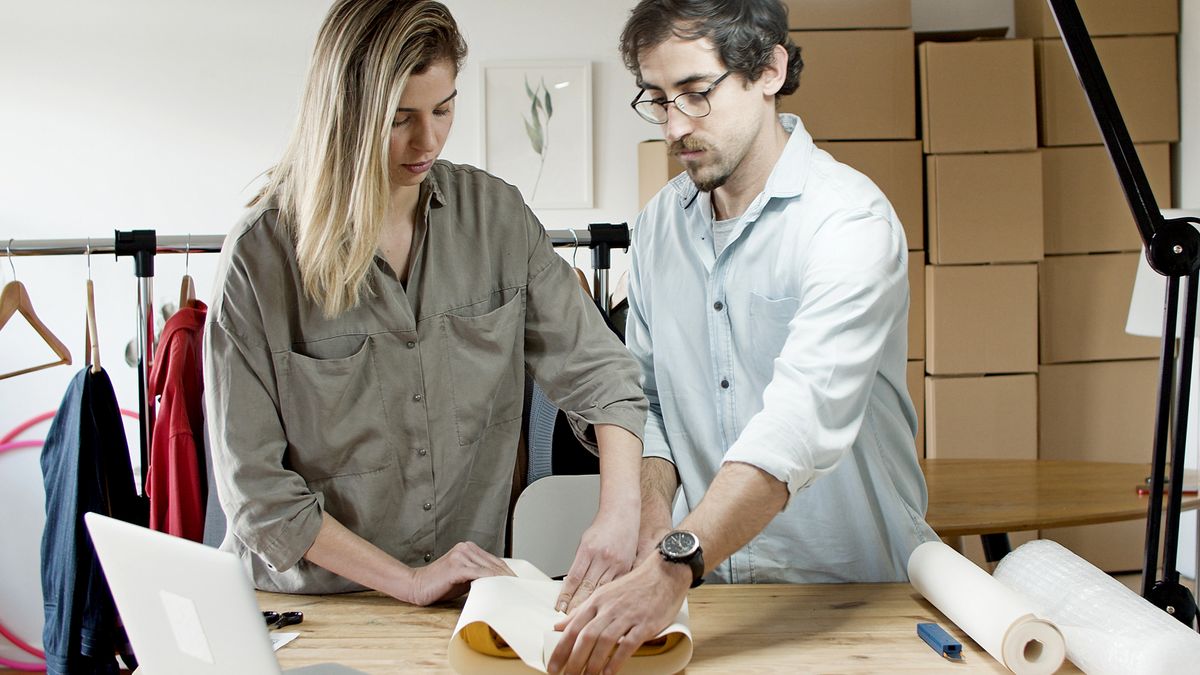 Team members packing orders in an online store's workspace, exemplifying efficient teamwork