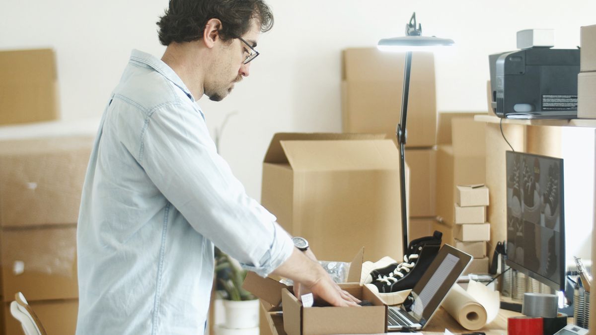 Businessman packing products in a home office for an online store startup