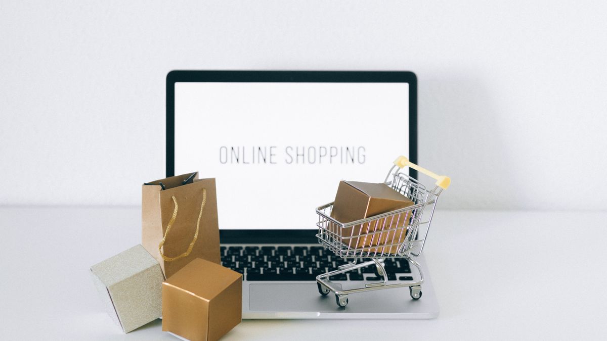 Laptop displaying online shopping with boxes and cart, representing ecommerce