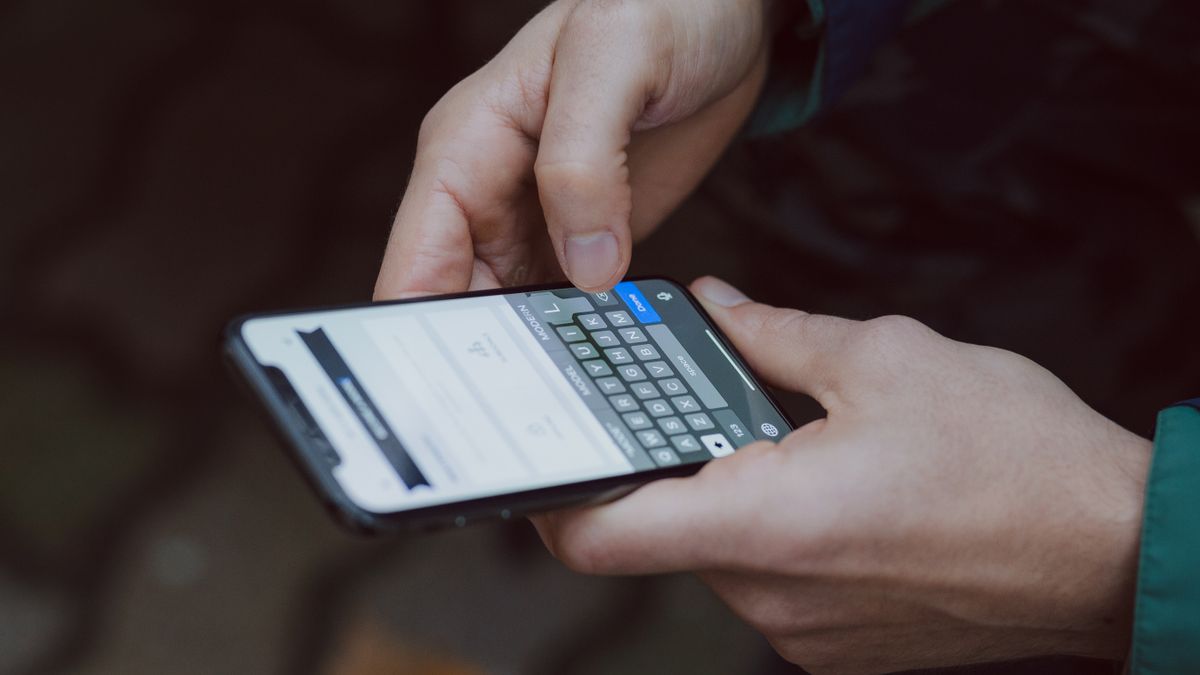 Close-up of person texting on a smartphone. Outdoor setting with wireless connectivity