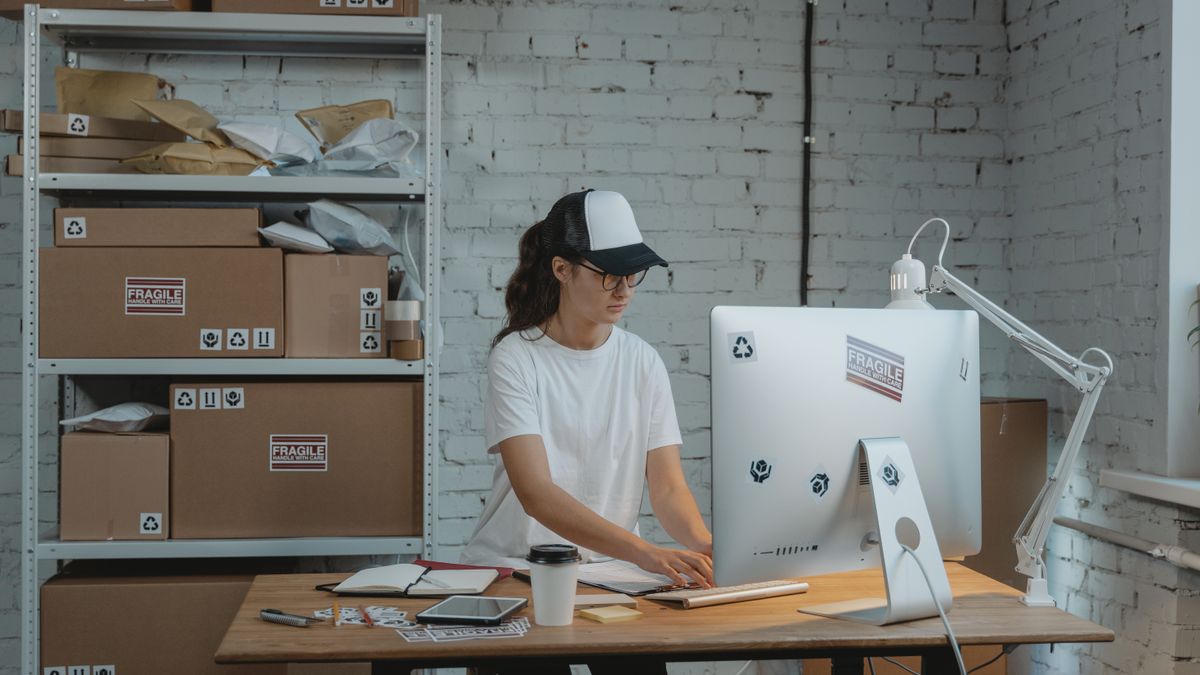 Focused female working on a computer in an organized industrial-style office space