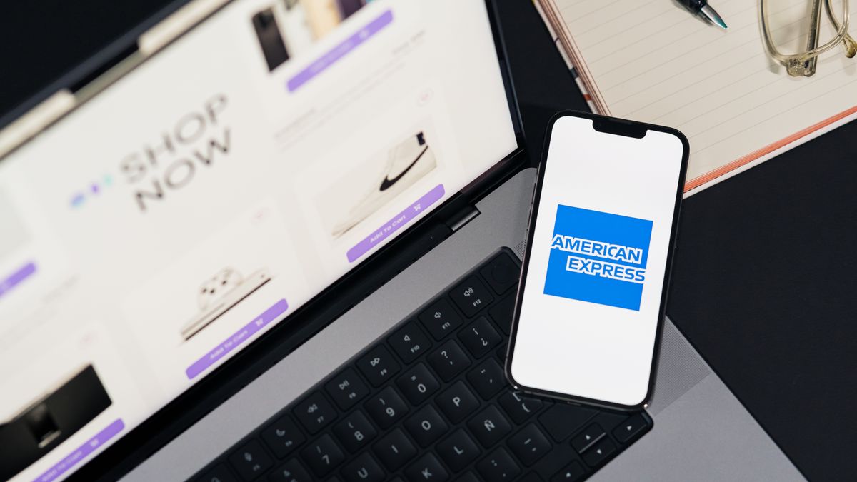 Smartphone displaying American Express logo on a laptop for online shopping convenience