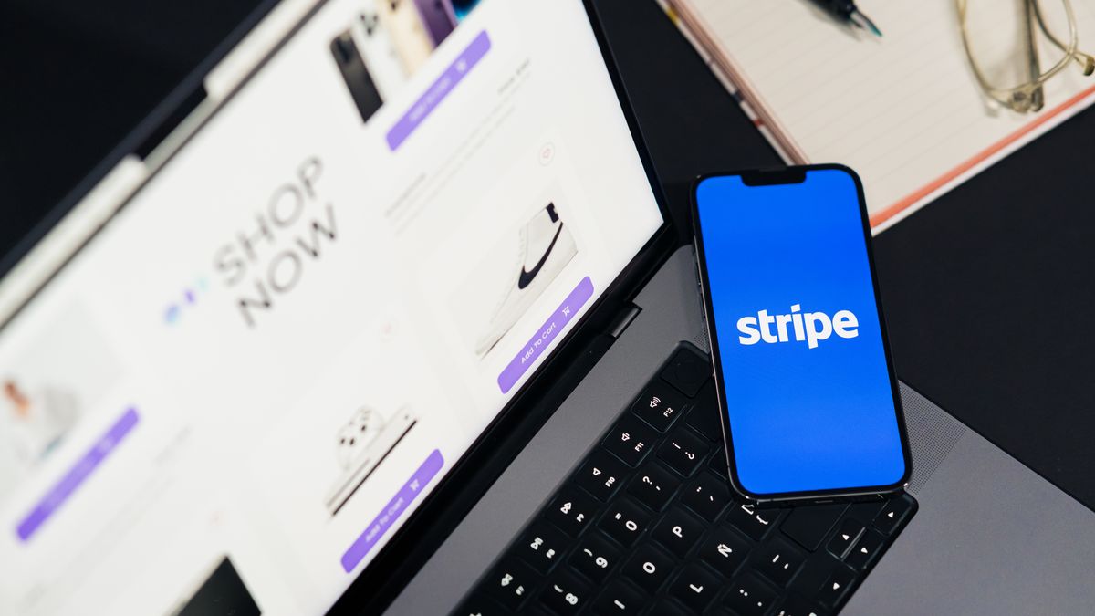 Mobile phone displaying Stripe app on a laptop with an eCommerce site open, symbolizing online shopping