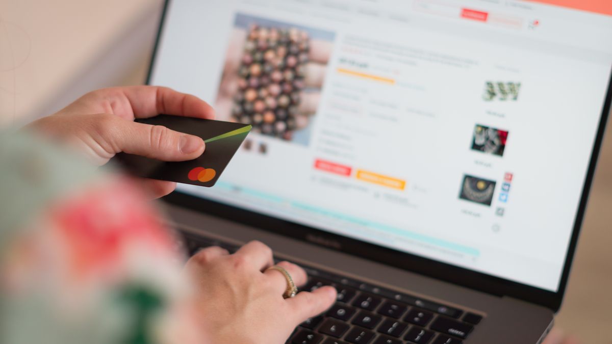 Engaging in online shopping using a credit card with a laptop for convenience and ease